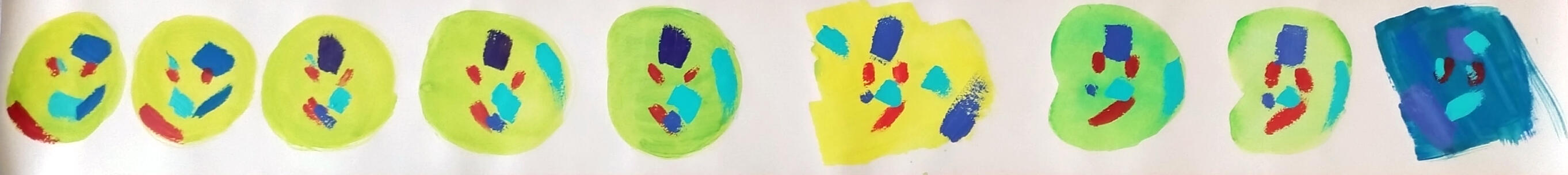 A photo of a roll of wallpaper. The wallpaper roll is opened and the inside has been painted with colorful blobs. Inside the blobs are abstract and colorful shapes.